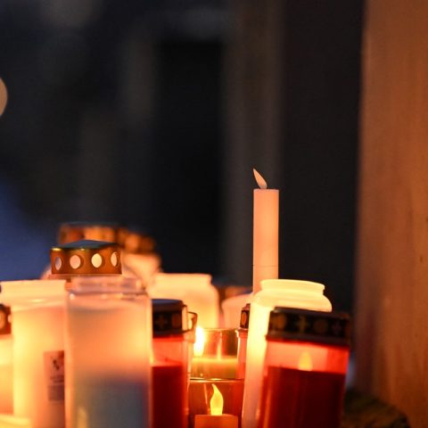Le luci delle candele ardono tra le stele coperte di neve al Memoriale dell'Olocausto a Berlino, Germania (Afp)