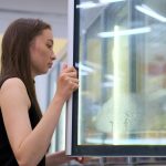 Young brunette taking ice cream from the fridge Storyblocks